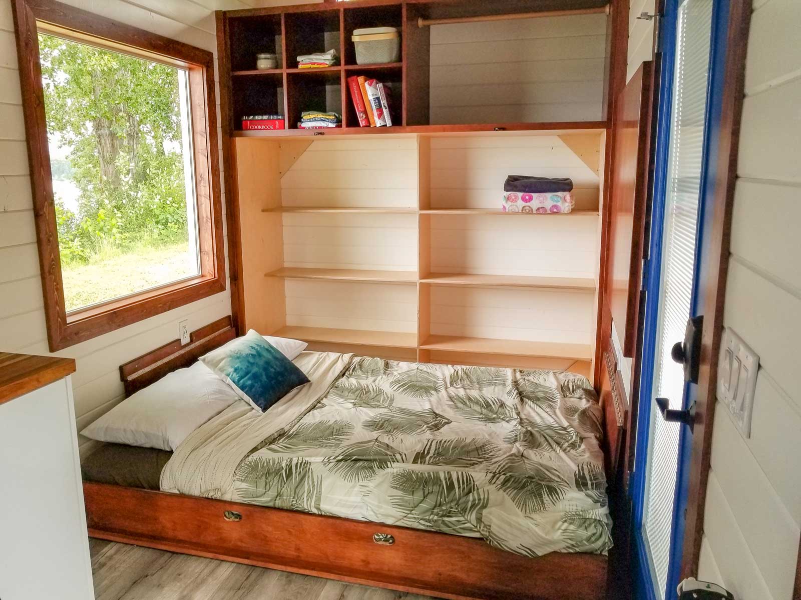 Murphy bed folded down in Cozy Cottage custom tiny home