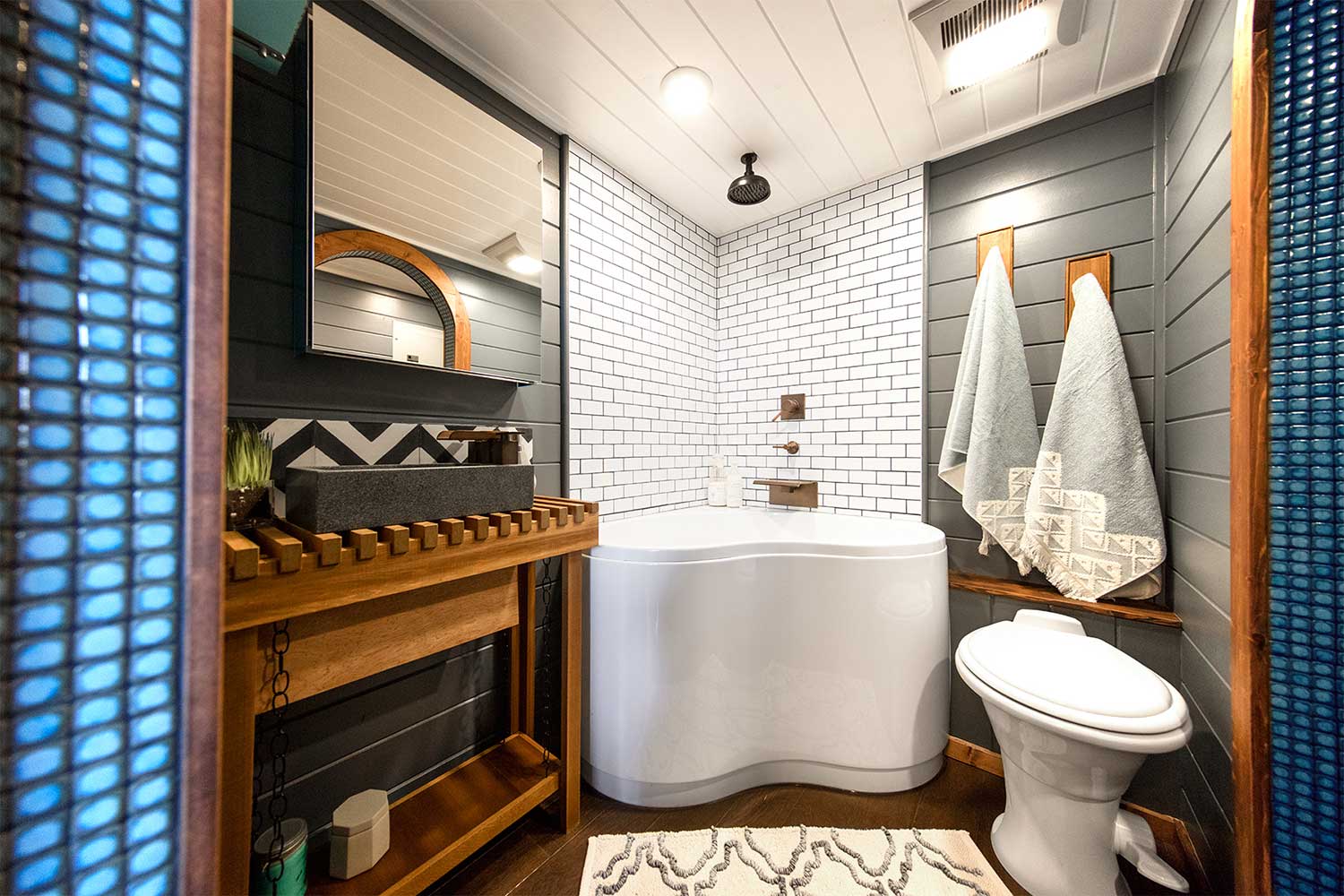 The Tiny Adventure Home's bathroom with tile shower and deep tub