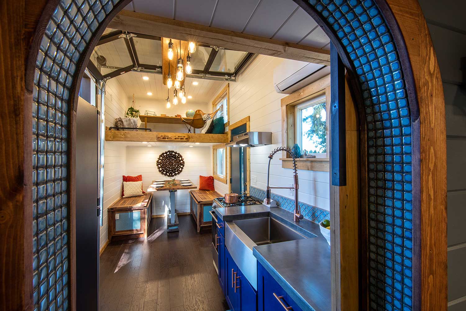 Interior of the Tiny Adventure Home with kitchen, dining area and loft