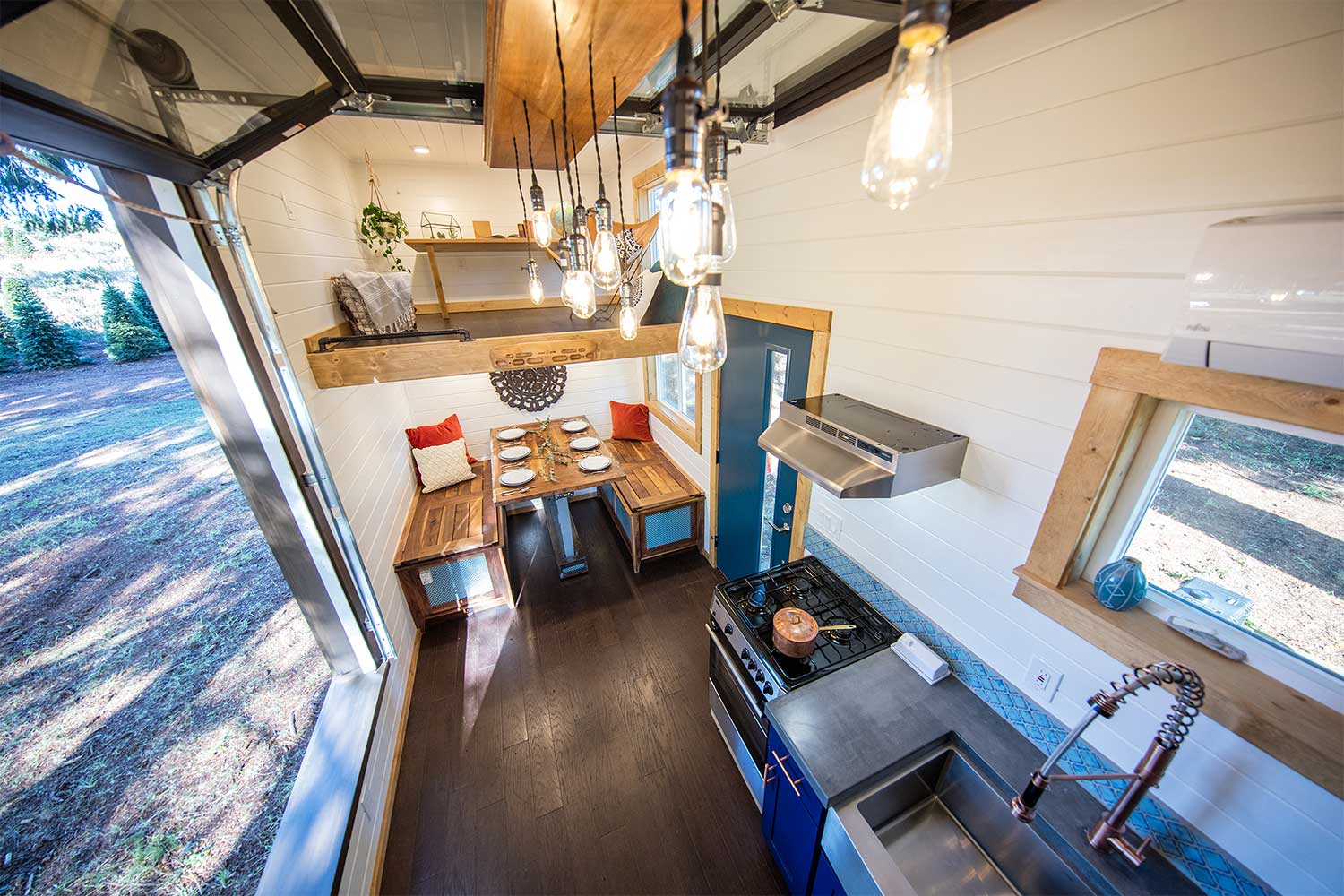 Interior of a custom tiny home, the Adventure, with garage door open