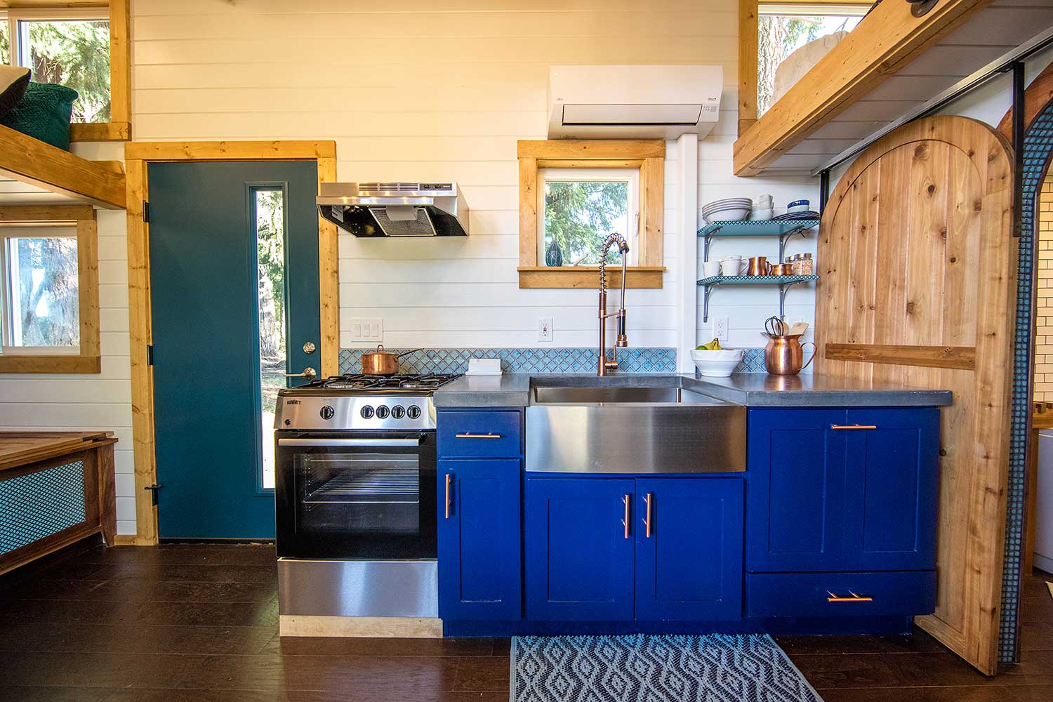 Kitchen in the Tiny Adventure Home with blue cabinets