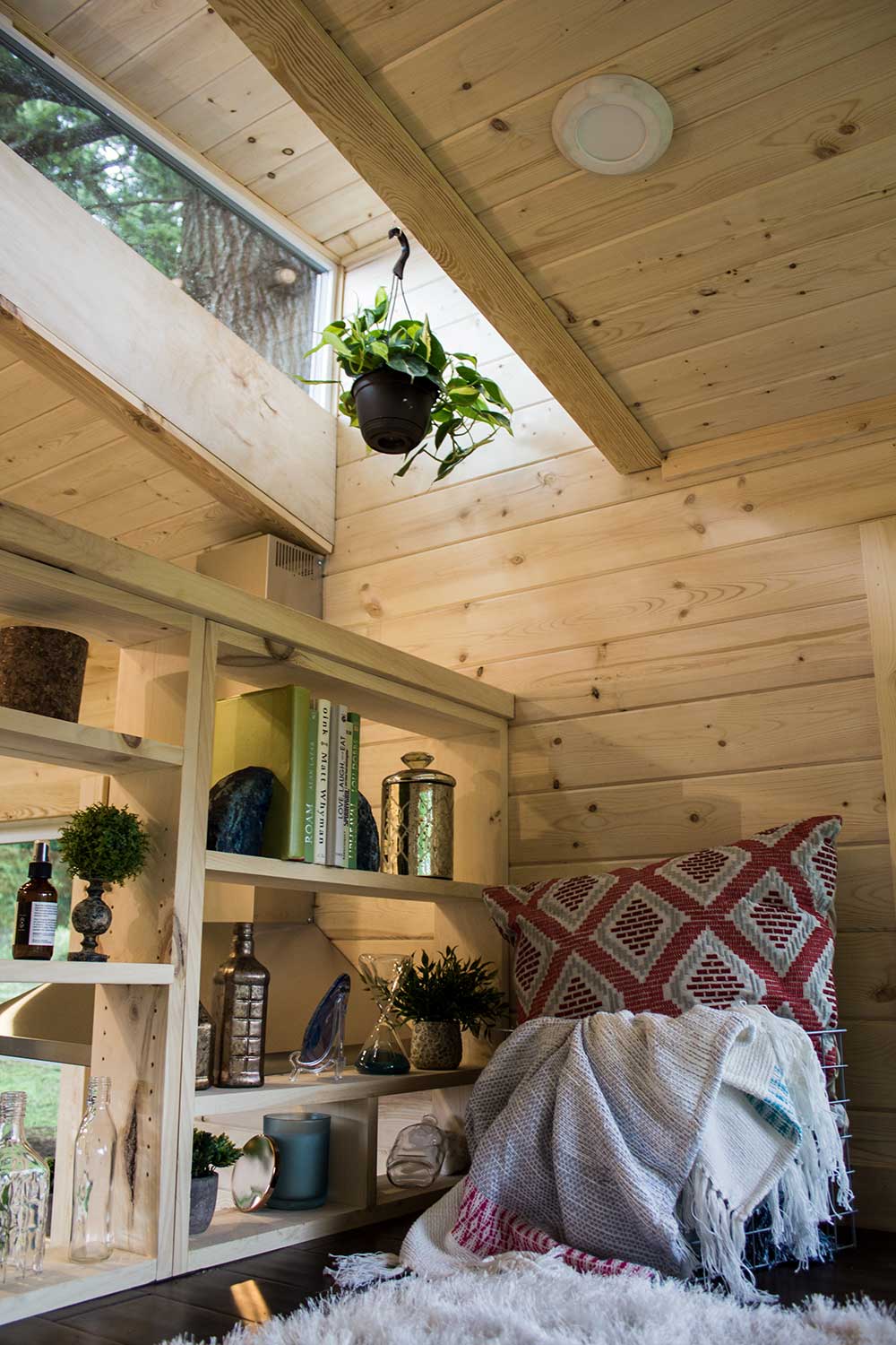 Custom storage in the bedroom of the Apothecary Tiny House