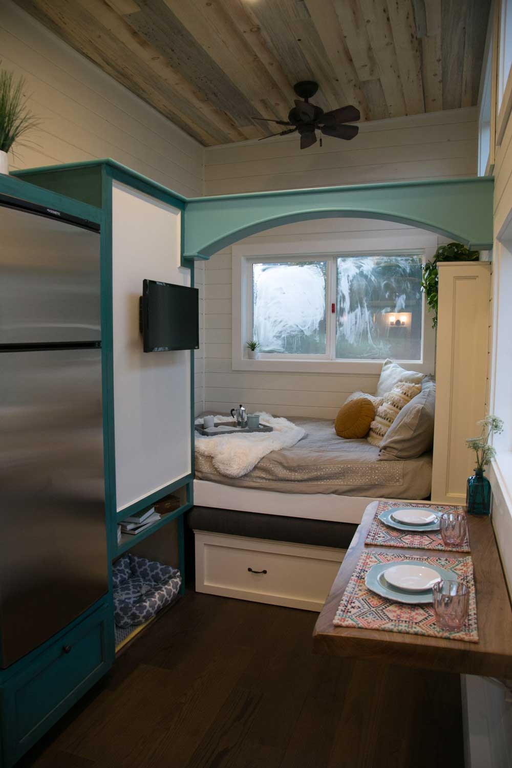 Interior of The Archway custom tiny house with kitchen, dining counter, and window seat