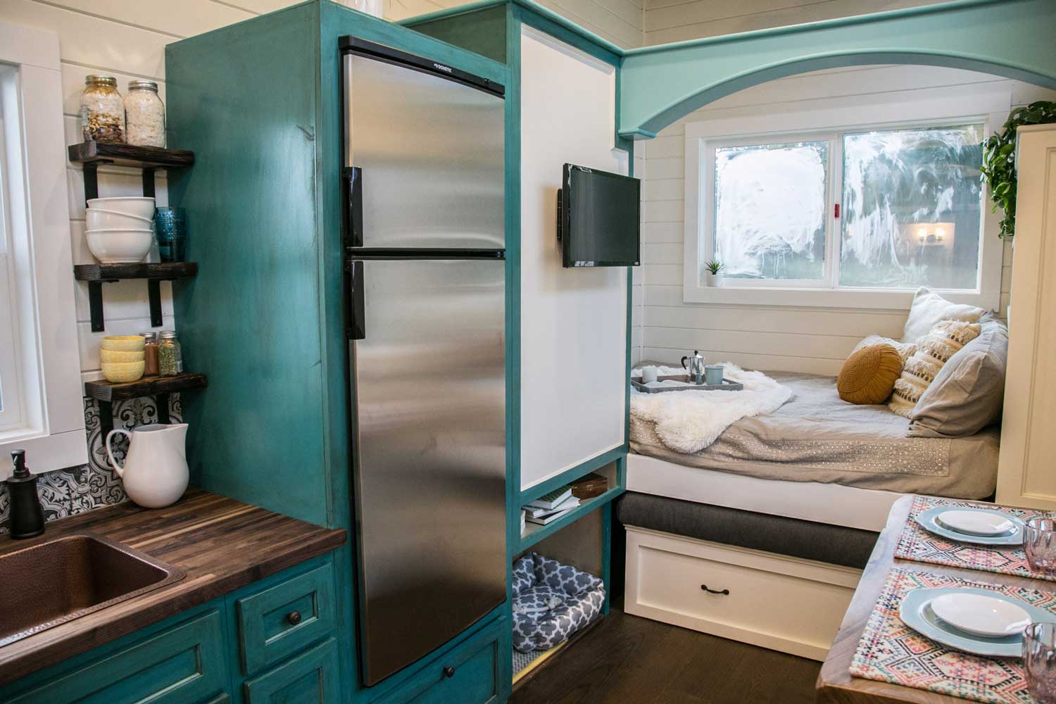 Kitchen and window seat in The Archway custom tiny house