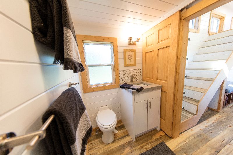Cheery bathroom in the Artists' Retreat custom tiny house