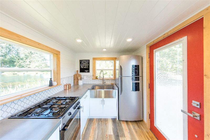 Bright colorful interior of the Artists' Retreat custom tiny home, showing the kitchen