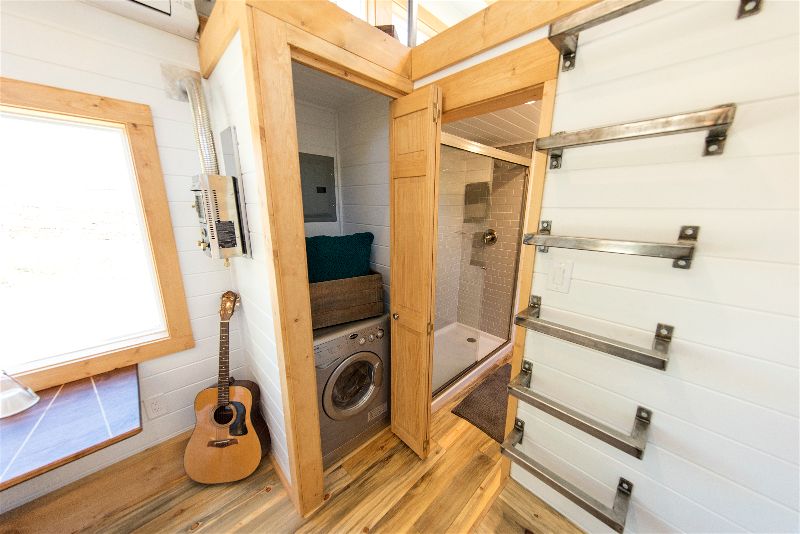 Storage space and washer / dryer combo in the Artists' Retreat custom tiny house