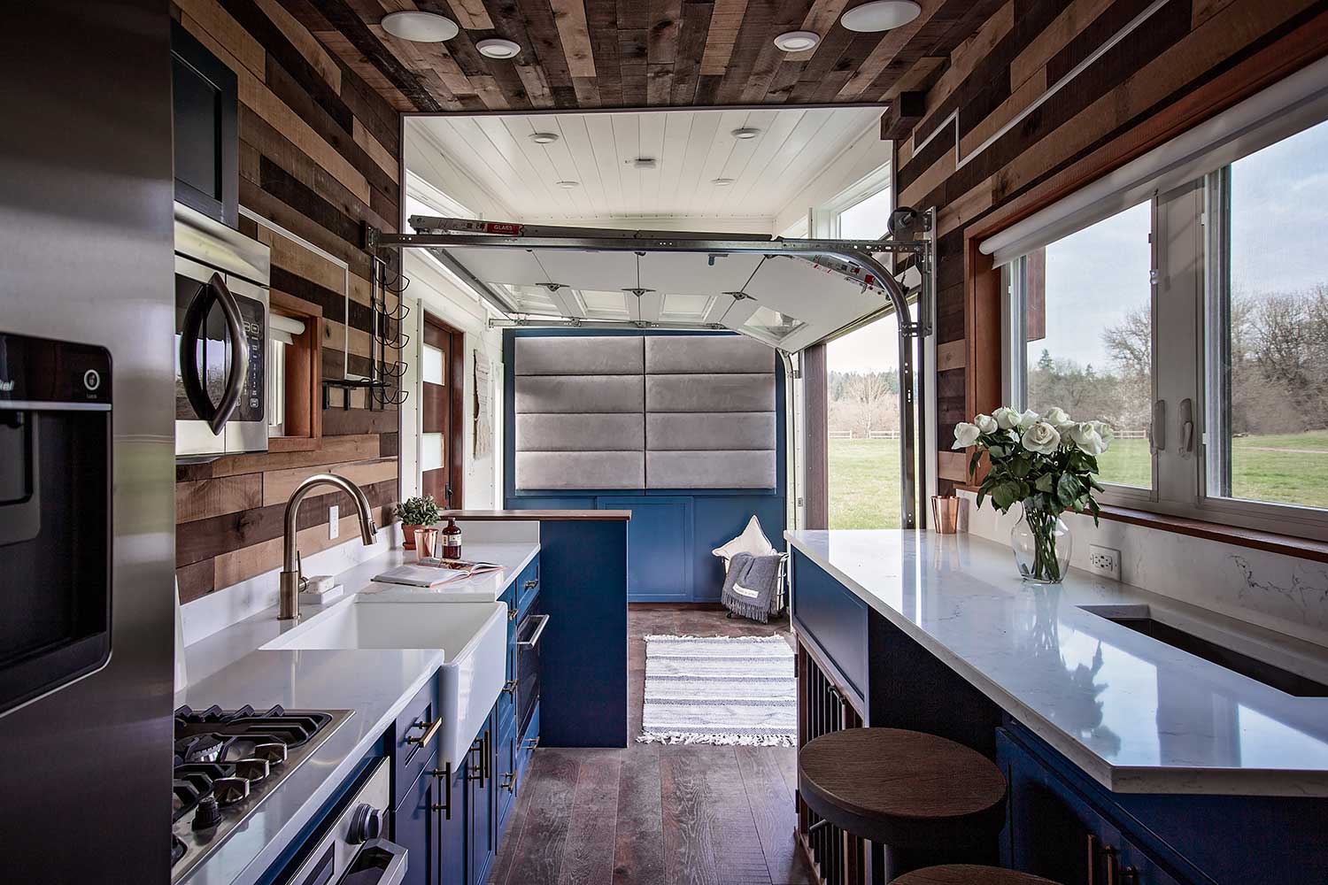 Interior of the Breezeway custom tiny home showing kitchen and garage door