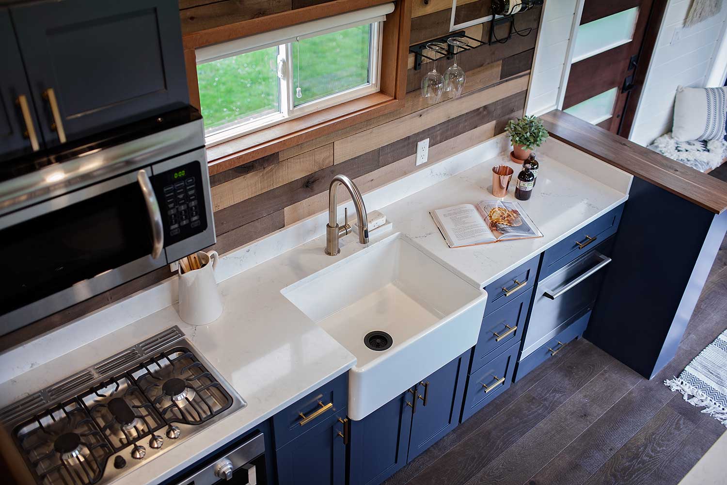 The kitcen with blue cabinets in Breezeway custom tiny home