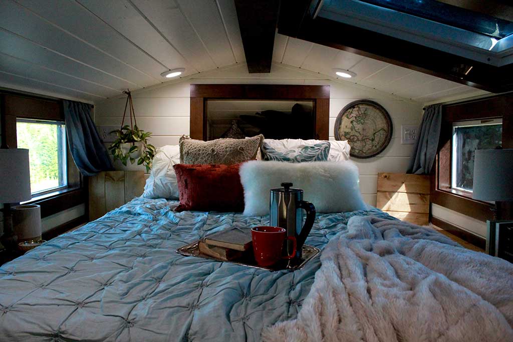 The Cozy Cottage custom tiny home's cozy sleeping loft