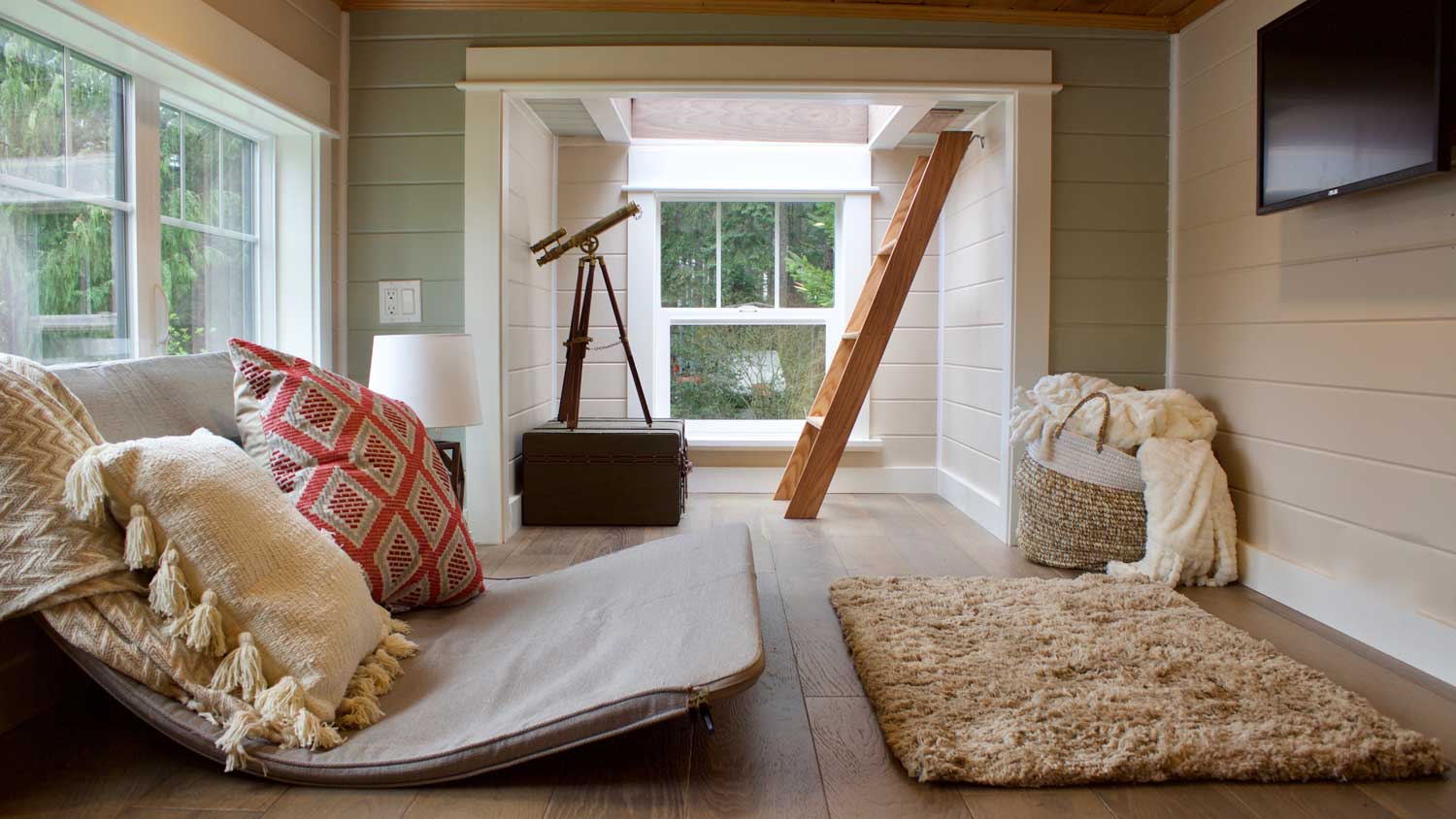 Interior of Tiny Craftsman Home with telescope and ladder to loft