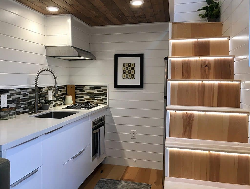 Kitchen and stairs to the loft in Home Of Zen custom tiny house
