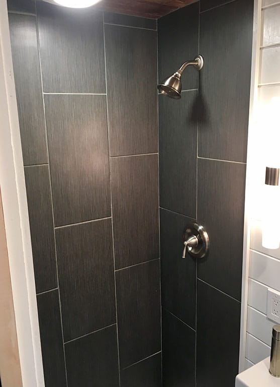 Tile shower in the Home Of Zen custom tiny house