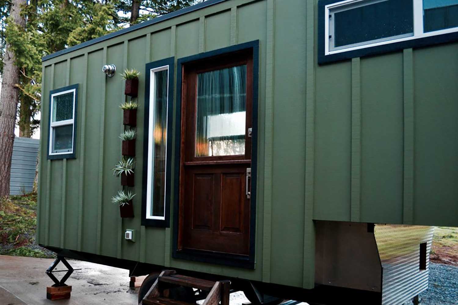 Outside view of The Huntsman Cabin custom tiny home's front door