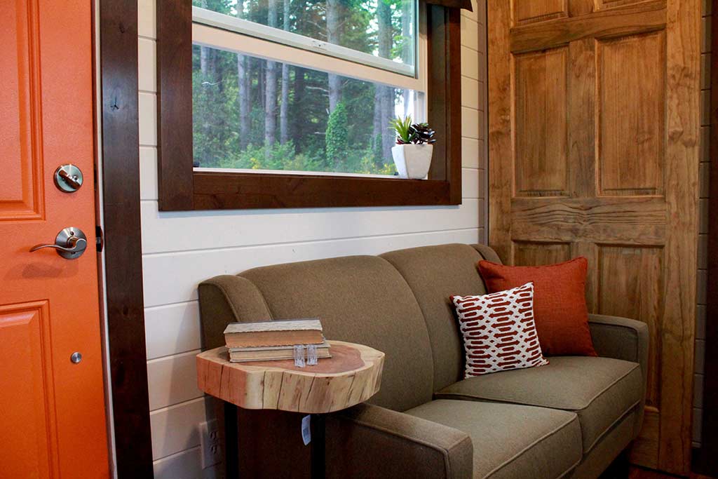 Couch with window in the The Kalani custom tiny home