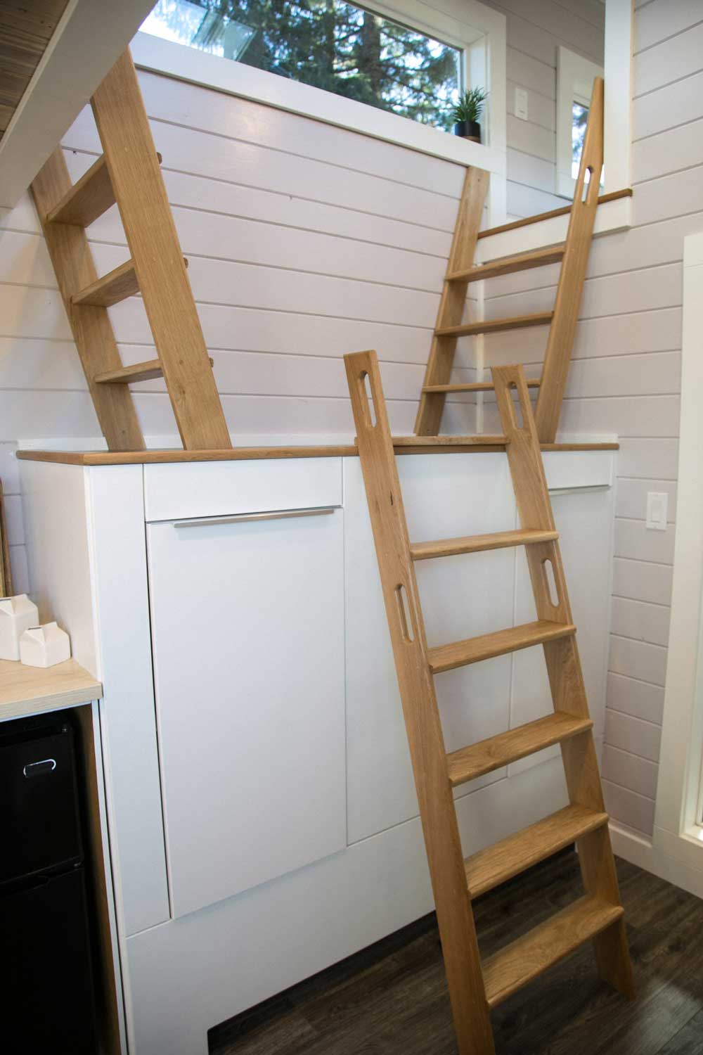 Ladders leading to different lofts in the Kentucky Donut Shop custom commercial tiny home