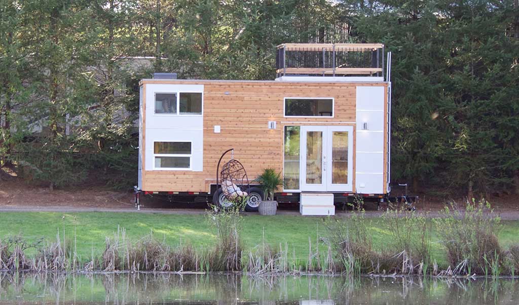 Outside of the Live / Work Tiny Home by a lake