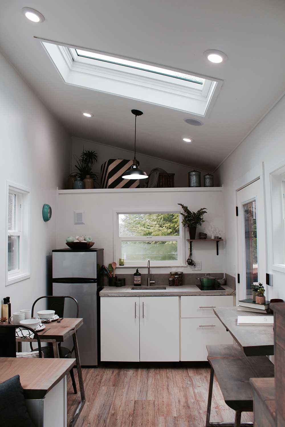 Kitchen, loft and skylight in an elegant custom tiny home designed and built by TIny Heirloom