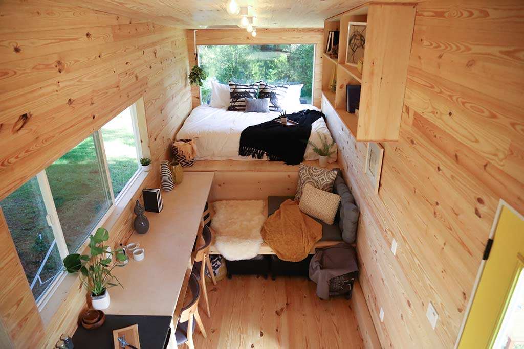 Overhead view of interior of the odern Shou Sugi Ban custom tiny home with eating counter and bed
