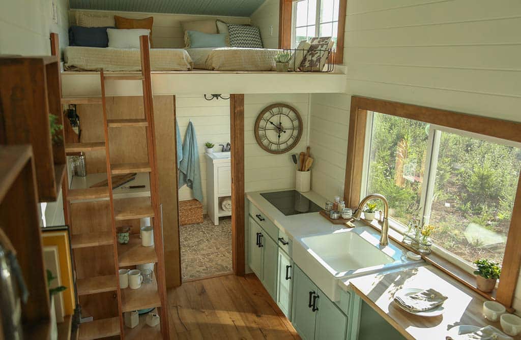 Kitchen and loft in the Rustic Farmhouse custom tiny home