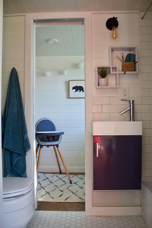 Bathroom sink and view of highchair in the Scandinavian Simplicity custom tiny home