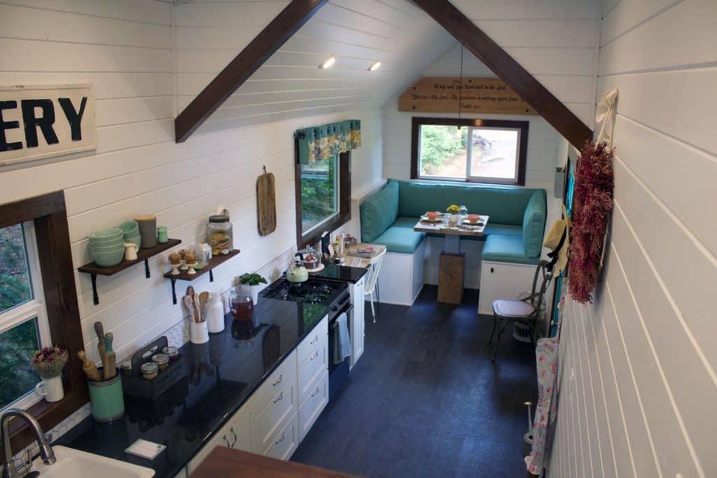 Overhead interior of Southern Charm custom tiny house showing kitchen and built-in dining area