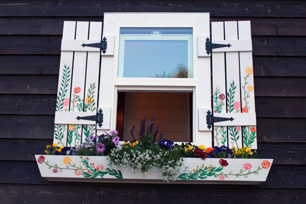 Cheerfully painted window with planter in the Southern Charm custom tiny house