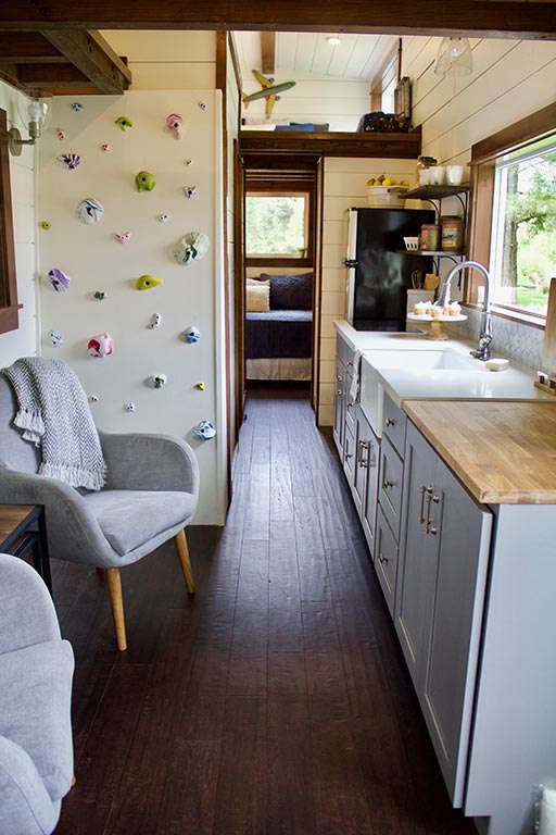The Tailgating Farmhouse custom tiny home's living room and kitchen