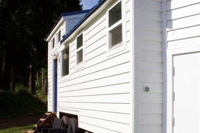 White outside walls of the Texan Tiny Farmhouse custom tiny home