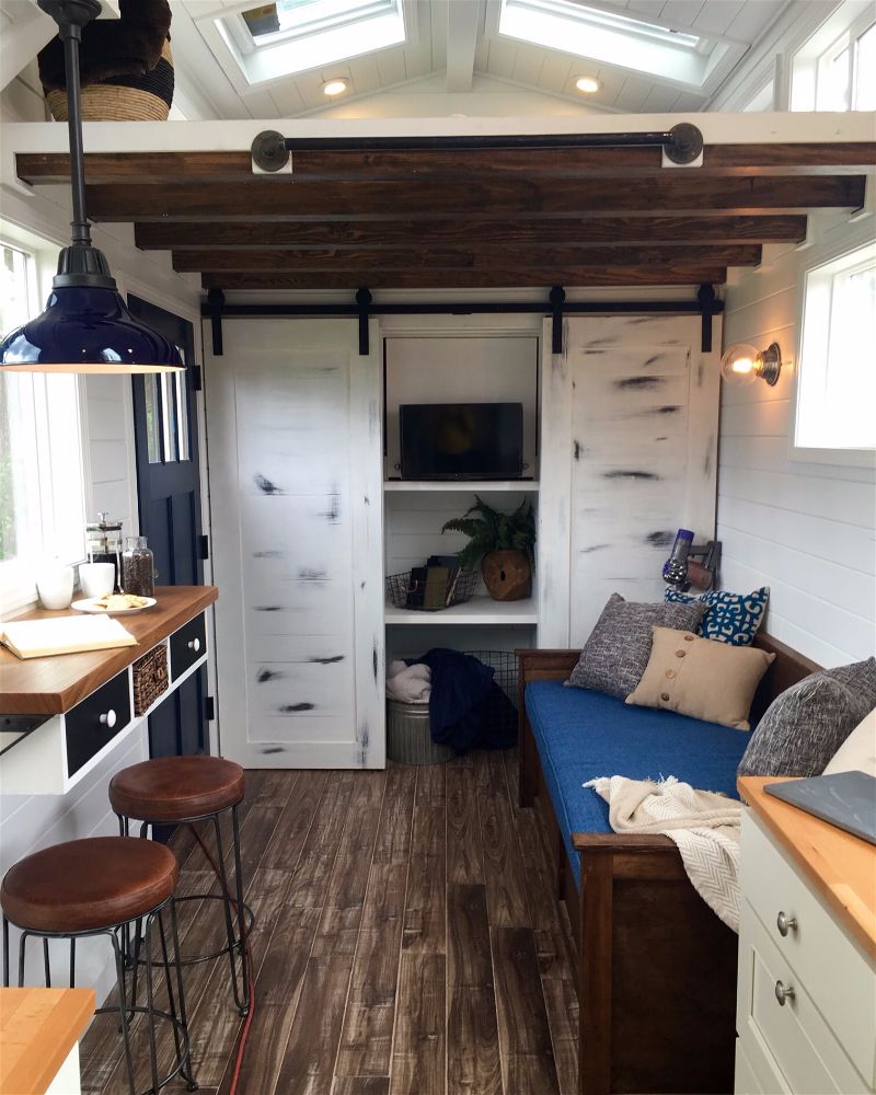 Interior of the Texan Tiny Farmhouse custom tiny home with living room and closet