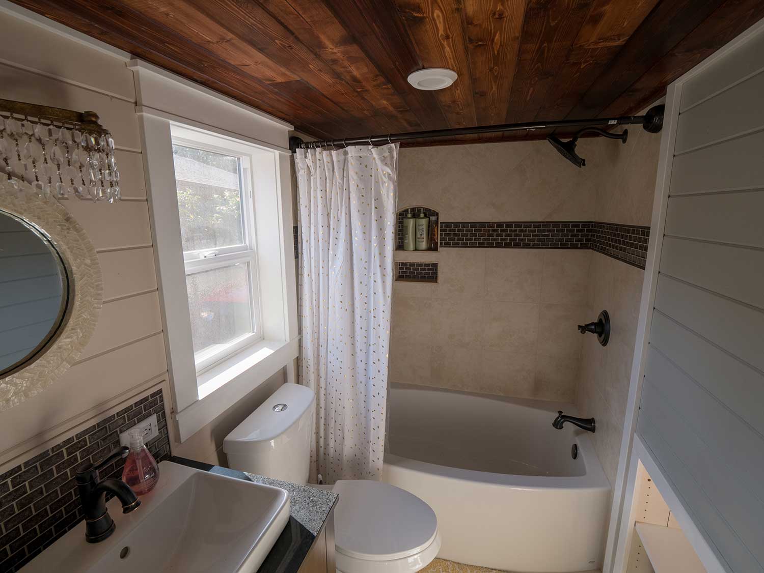 The Theater Home custom tiny house's bathroom with tub