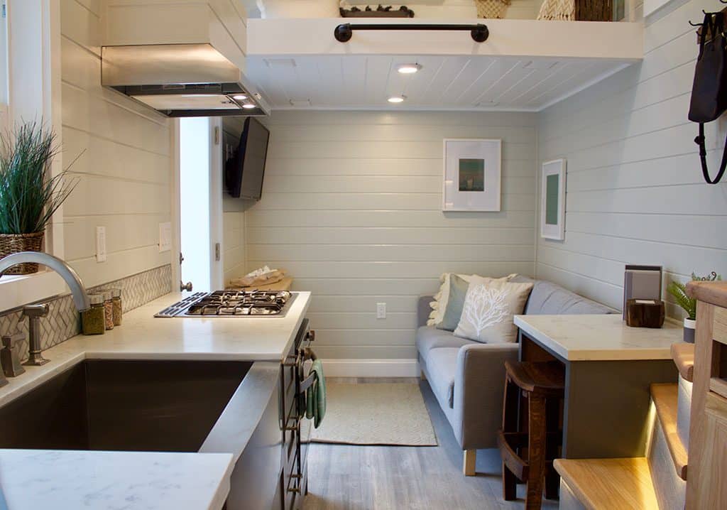 Kitchen and living room in the Tiny Beach House custom tiny house