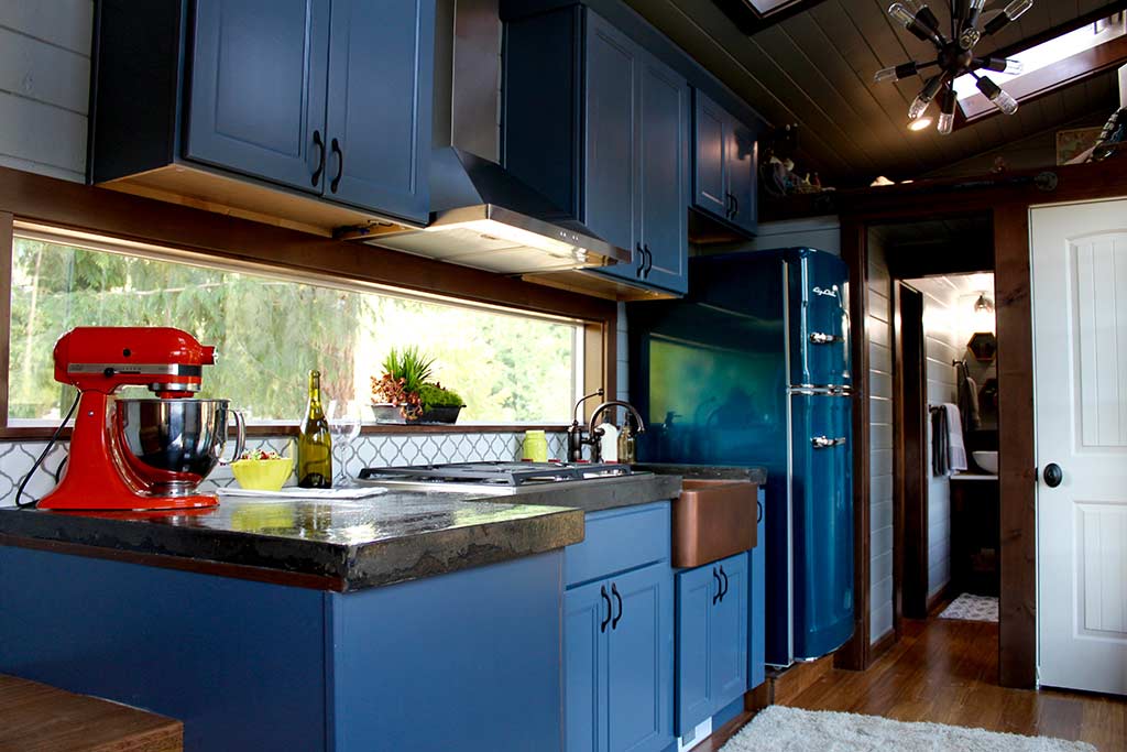 Kitchen in the Tiny Home, Big Family custom tiny house with blue cabinets