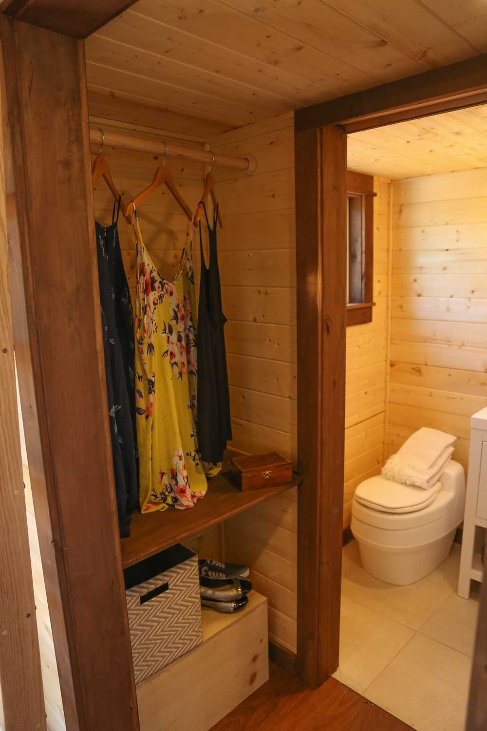 The closet and bathroom of the Tropical Getaway custom tiny house