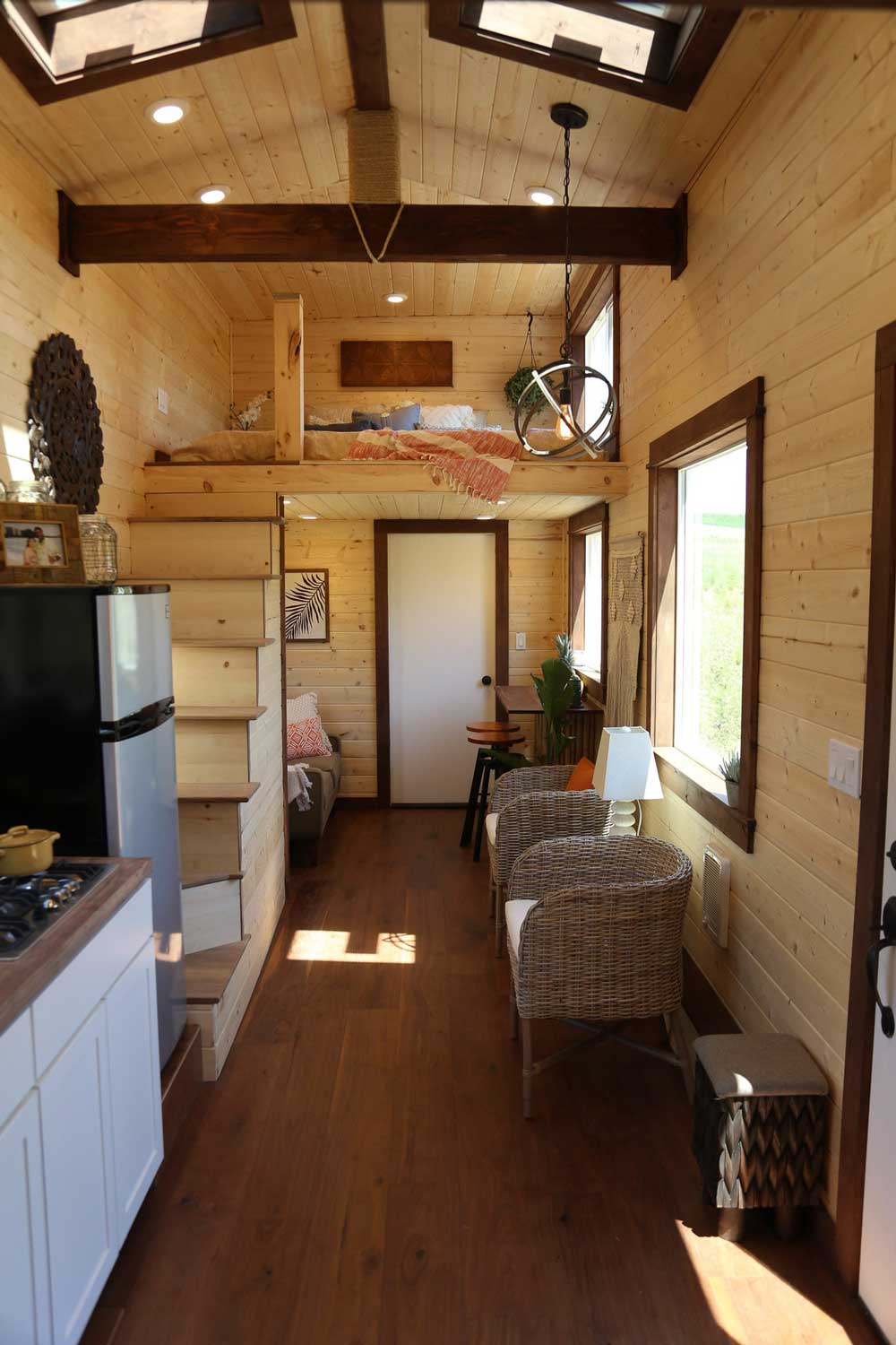 The Tropical Getaway custom tiny house's kitchen and living room