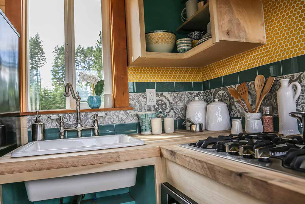 Kitchen in the Beachy Bohemian custom tiny home with custom tilework