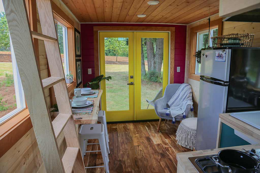Living room and french doors in the Beachy Bohemian custom tiny home