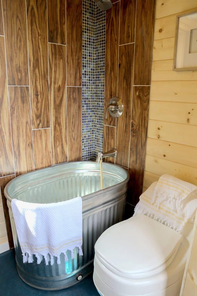 Metal tub in the bathroom of the Beachy Bohemian custom tiny home