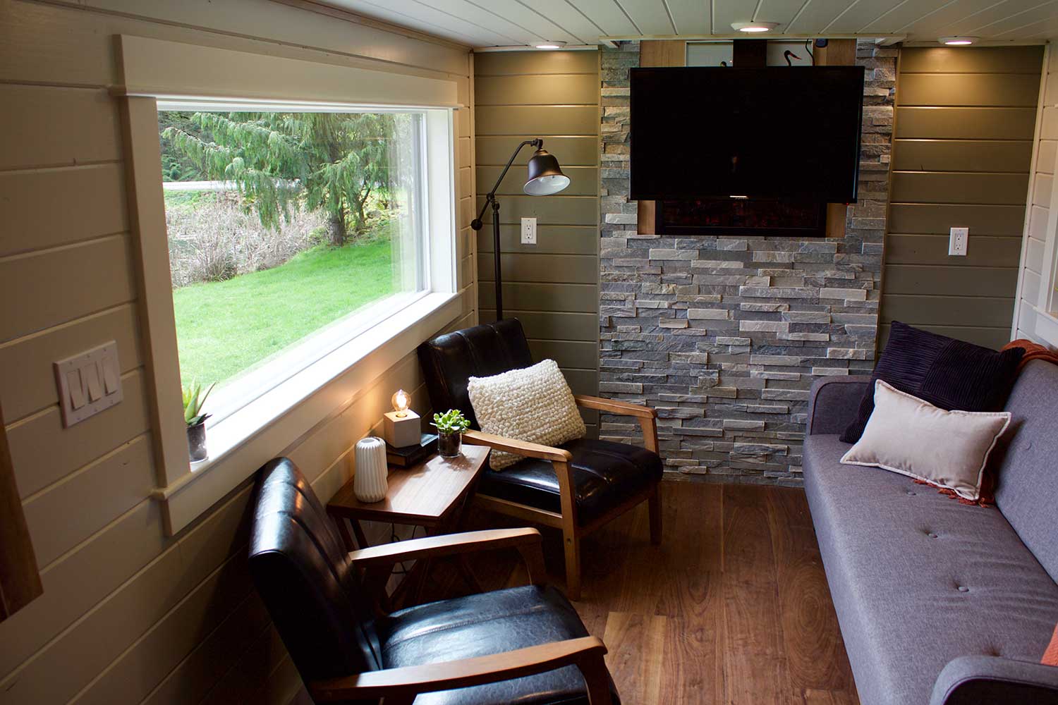 Living room with large window in the Modern Mountain House custom tiny house