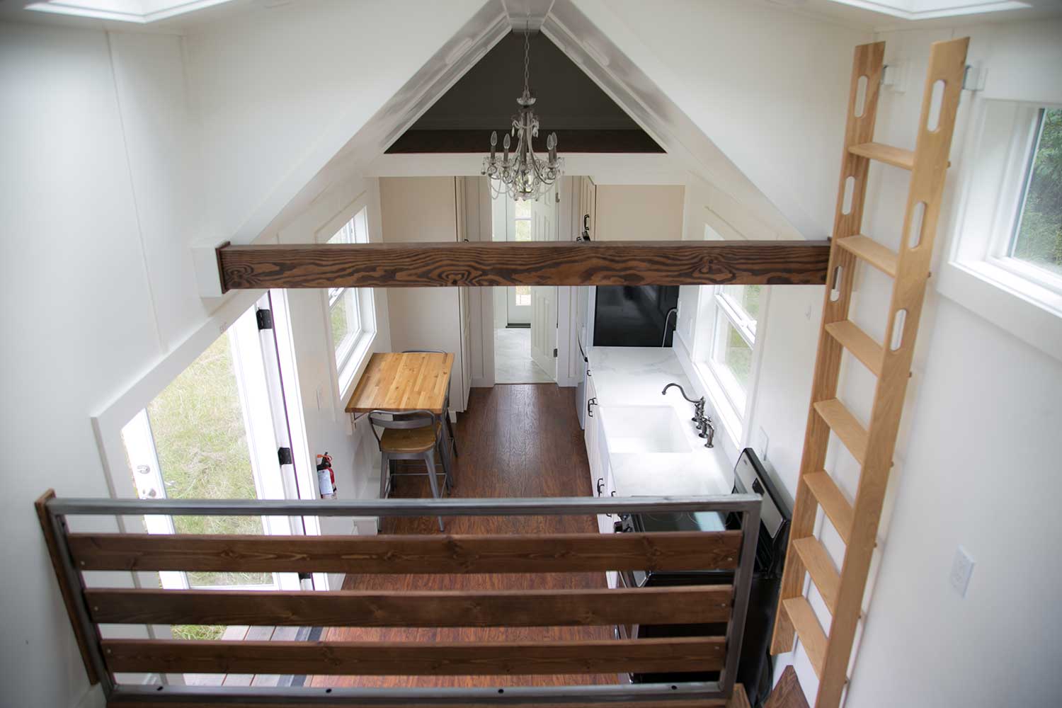 View down from the loft of the Maribelle Blue custom tiny home