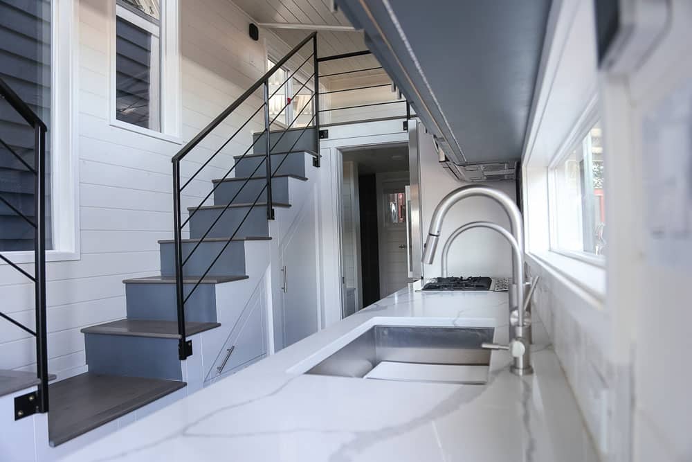 Kitchen and loft stairs of the Contempo custom tiny home