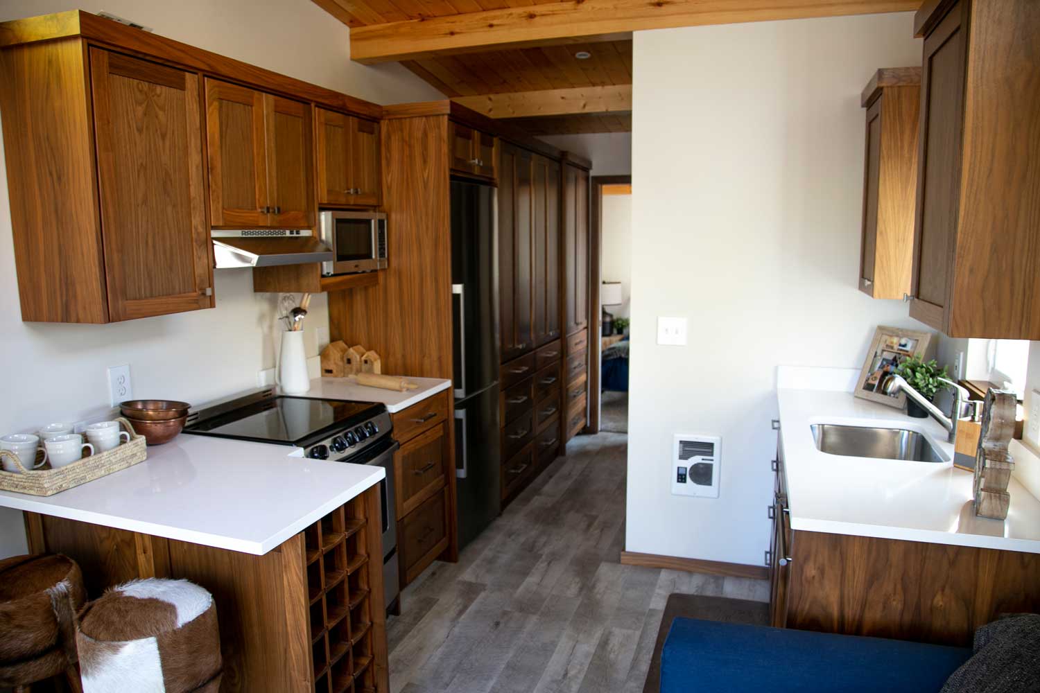 Kitchen of custom tiny house called the Log Cabin