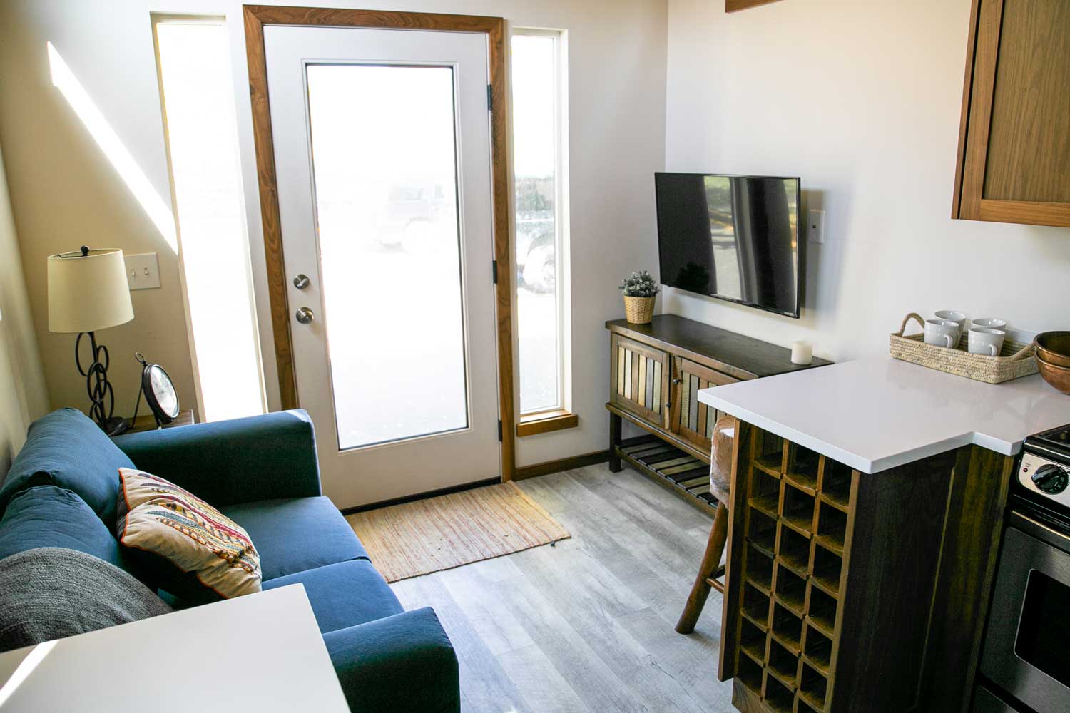 Entryway and living room of the Log Cabin tiny home custom-built by