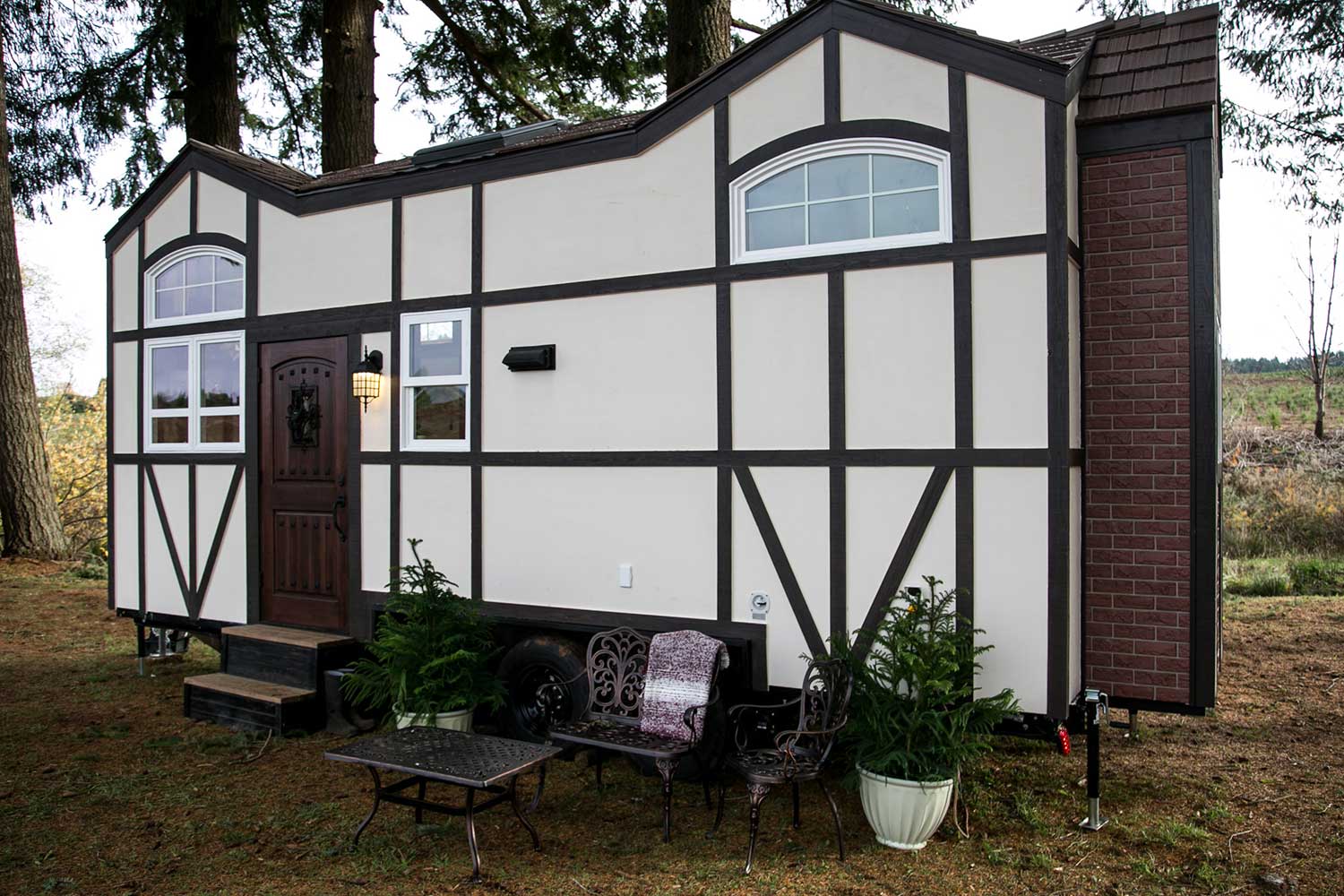 Outside view of the Tudor custom tiny house sold by Tiny Heirloom