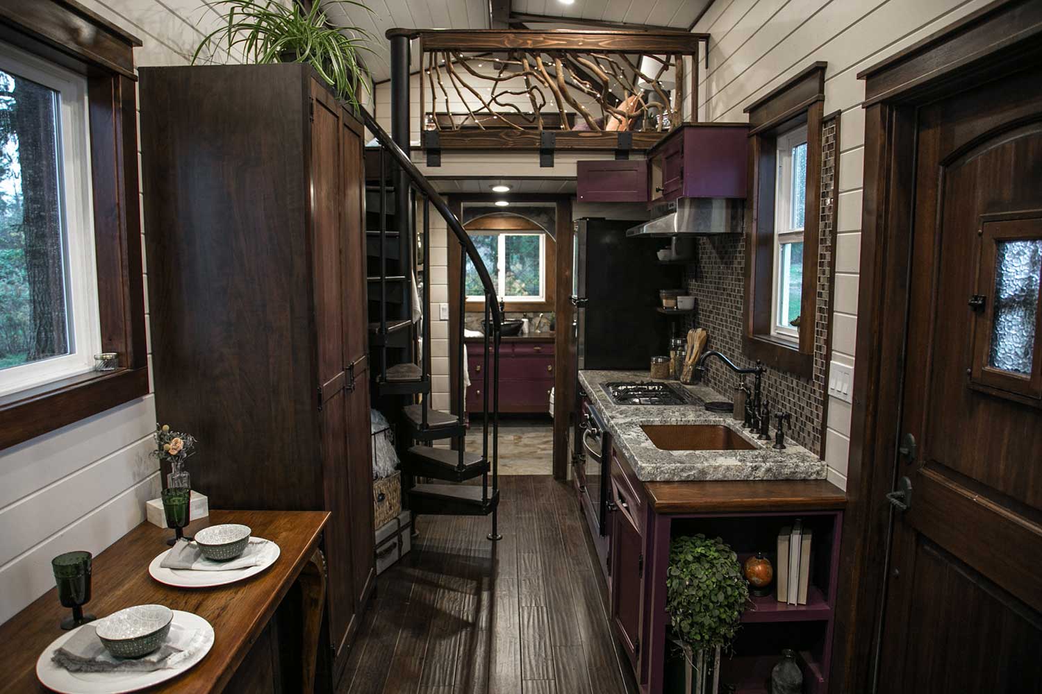 Spiral staircase to loft and custom metalwork in the interior of the Tudor custom tiny house