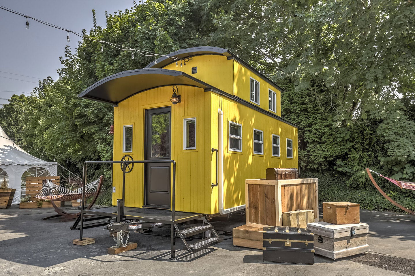A quirky yellow tiny home serving as a unit in a tiny house hotel