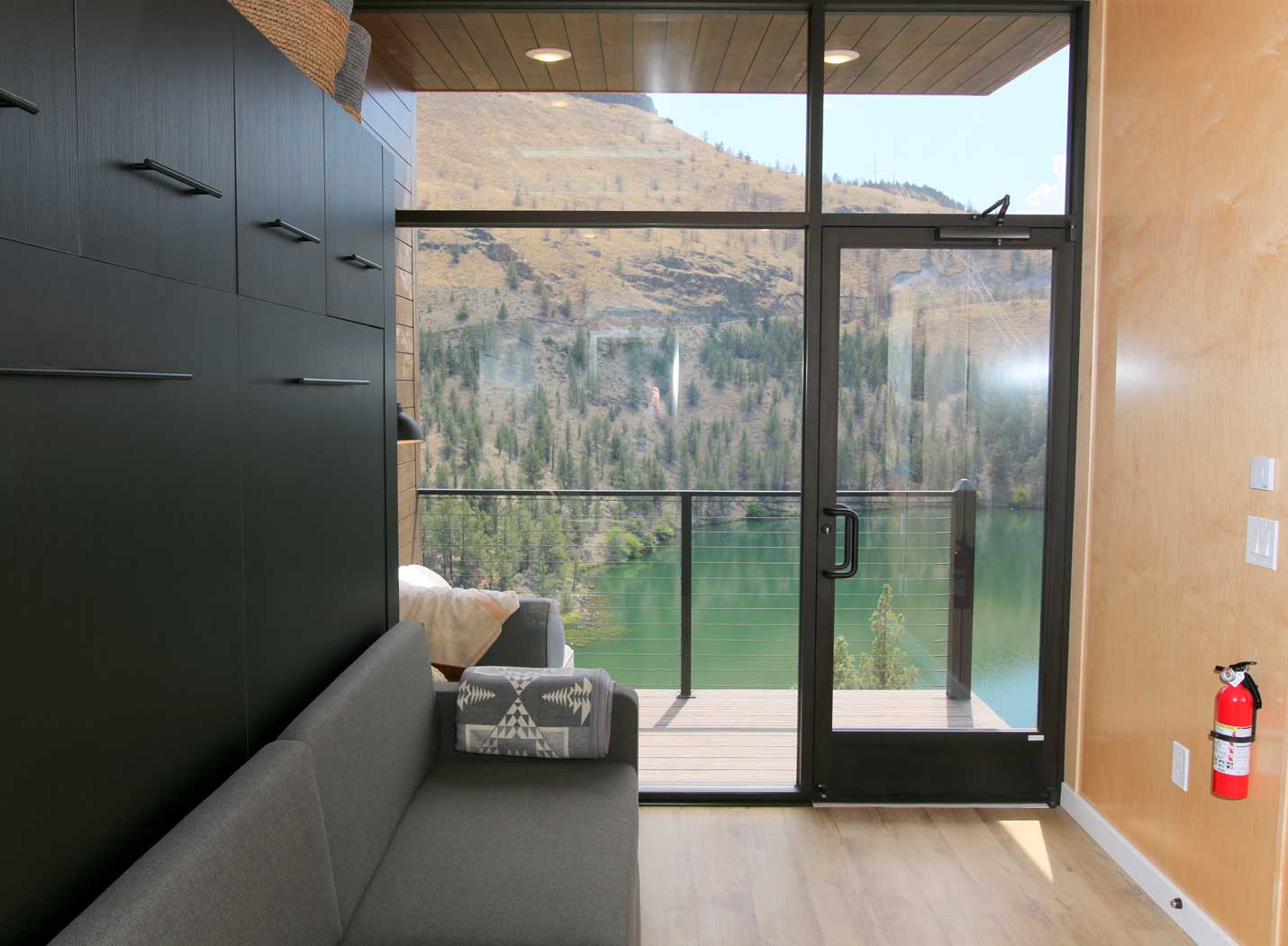 eXpanse tiny home with huge windows showing a beautiful lake