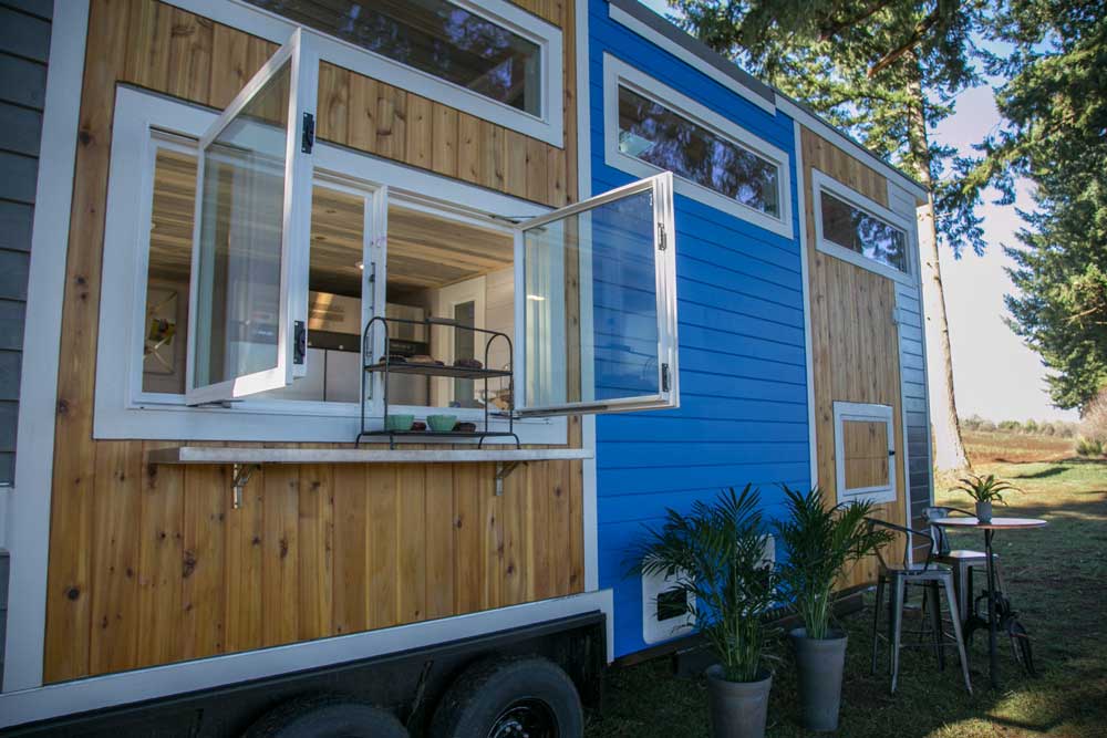 Exterior of a custom tiny house donut show showing the serving window open for business