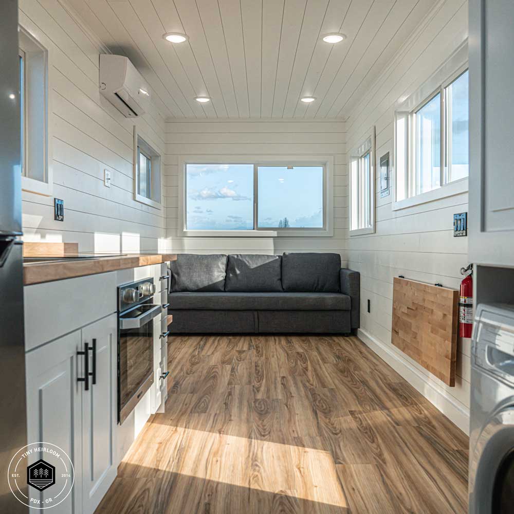 Legacy farmhouse style tiny house interior showing kitchen and couch