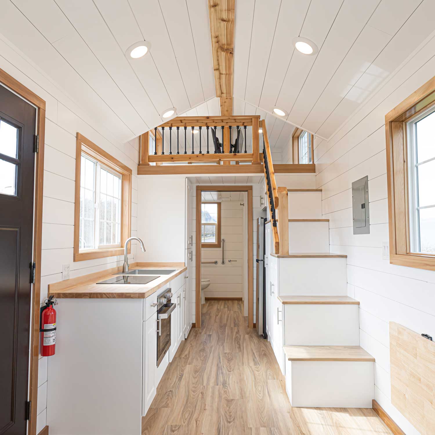 Heritage tiny home in the craftsman style, showing the interior with loft and kitchen